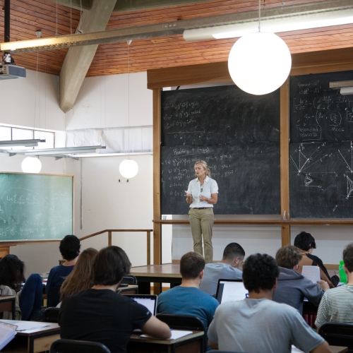 A teacher in a classroom with students.